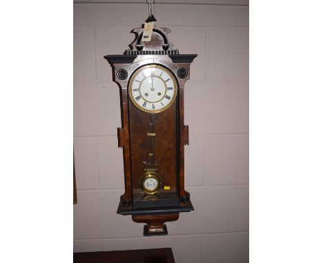 A late 19th Century wall clock in walnut case with enamel dial.