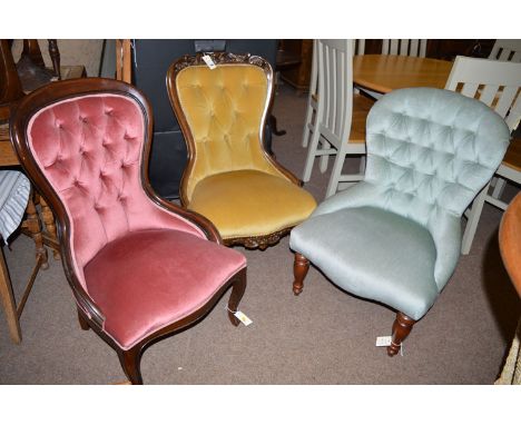 Three reproduction button back nursing chairs, one with leaf scroll carving.