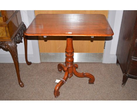 A 19th Century stained wood tilt action tripod table, the rectangular top raised on baluster support and scrolling legs, 72cm