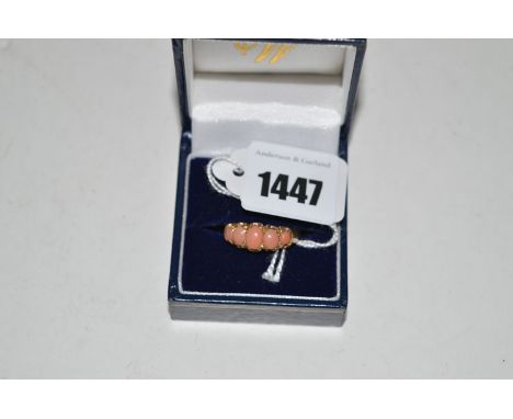 A coral set ring, on yellow metal shank stamped '18c.', ring size O.