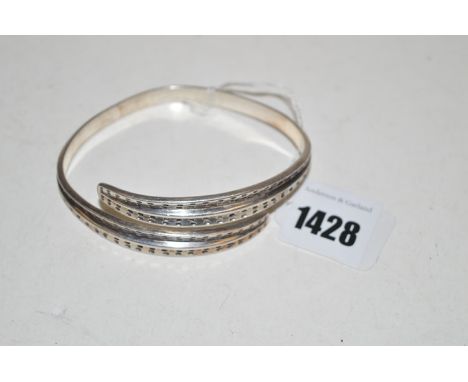 A silver bangle by David Andersen.