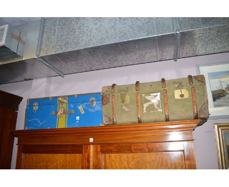 A canvas and leather bound travelling trunk; together with a tin covered trunk.