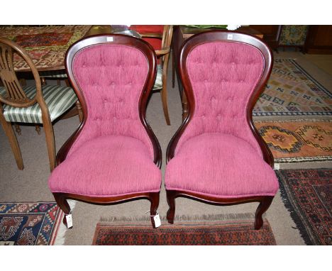 A pair of reproduction button back nursing chairs.