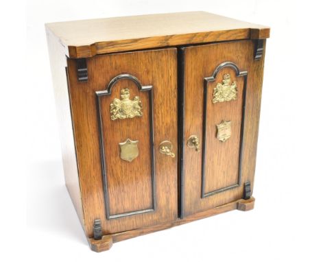 A BRASS MOUNTED EDWARDIAN SMOKERS CABINET  the doors opening to pipe rack compartment and three drawers, 30cm wide 22cm deep 