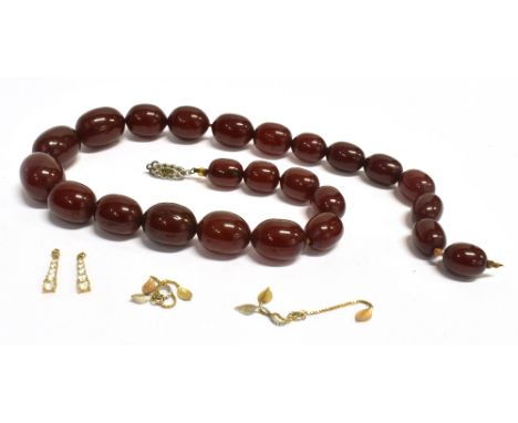 A VINTAGE CHERRY AMBER COLOURED BEAD NECKLACE  together with a matched pair of cubic zirconia set small pendant drops and a m