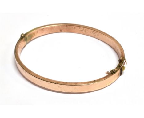 AN EDWARDIAN ROSE GOLD BANGLE The bangle hallmarked for Birmingham 1904 Maker M.W Ld, 0.5 cm wide, 5.7 cm diameter, weight 6.