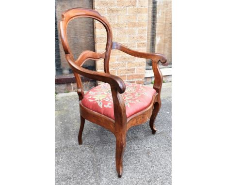 A CONTINENTAL WALNUT ARMCHAIR  with tapestry upholstered drop-in seat, on cabriole supports