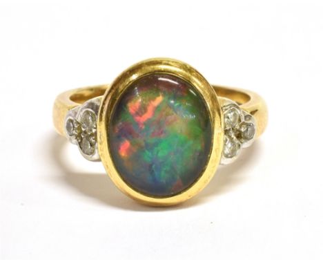 AN OPAL AND DIAMOND COCKTAIL RING  the oval black opal doublet measuring approx. 1.2 x 0.9cm and flanked each side with three