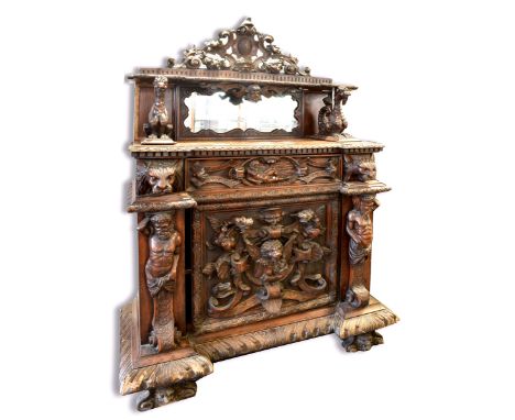 A HIGHLY CARVED FLEMISH SIDE CABINET the mirrored back with scrolling frieze above shelf supported by mythical beasts, the in