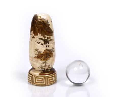 A Japanese ovoid ivory crystal ball stand with ball Meiji period former decorated in gold hiramakiye with seascape of scatter