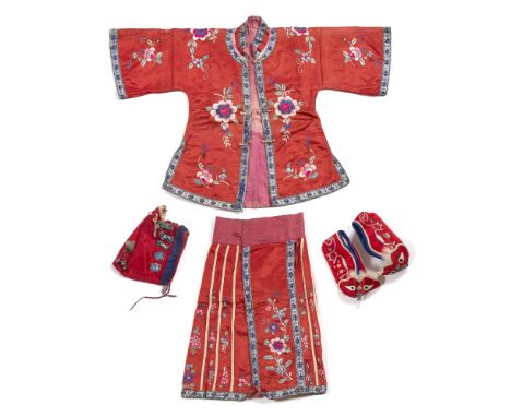 A Chinese child's robe, jacket, shoes, skirt and hat circa 1910-1920 of red ground with embroidered decoration, the hat havin