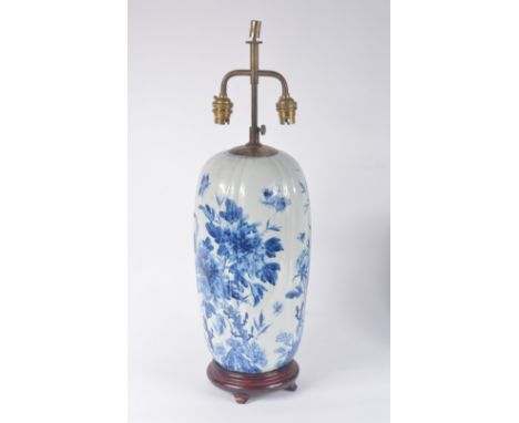 A Japanese blue and white porcelain vase 19th Century of ovoid lobed form decorated flowers, foliage, insects and butterflies