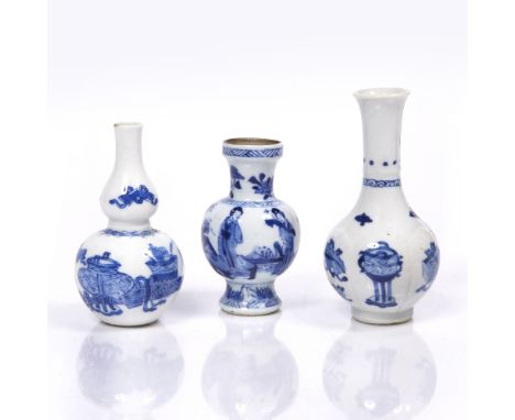 A Chinese blue and white miniature bottle vase Kangxi (1662-1722) with raised lotus petal panels and decorated alternately wi