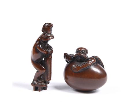 A Japanese wood netsuke of a muscular Tengu-no-tamago early 19th Century detailed and patinated Tamba School, and a standing 