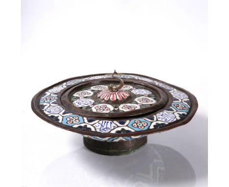 A Syrian brass lidded basin  with blue, red and white enamel within an embossed pattern of medallions finished with hand pain