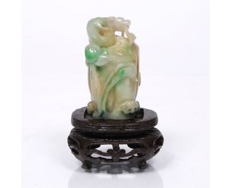 A Chinese pierced and craved jade pebble of a chi lin 19th Century holding a ling chih fungus spray as it squats and coils on