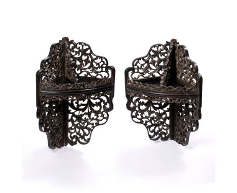 A pair of Chinese hardwood corner brackets late 19th Century of foliate scroll form, 54cm high x 30cm