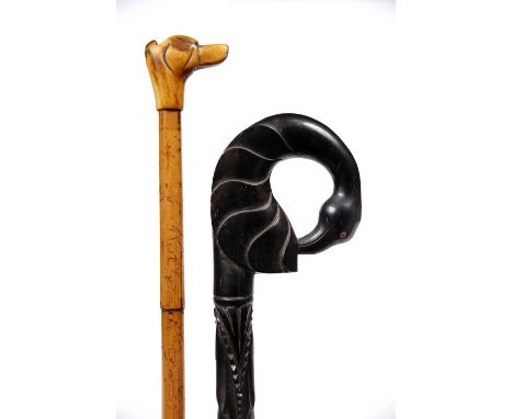An Indian ebony and inlaid walking stick circa 1900 with bird head handle and one other bamboo and bone walking stick with wh