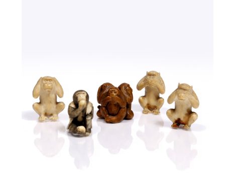 A Japanese ivory netsuke late Meiji in the form of a seated monkey in a sleeveless jacket consuming a peach and holding a sec