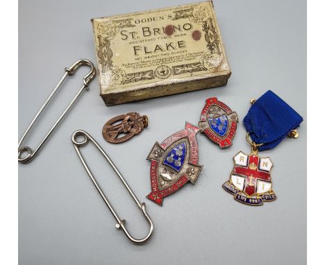 A Vintage St. Bruno tobacco advertising tin containing various brooches and medals. Includes The Deva Hospital training schoo