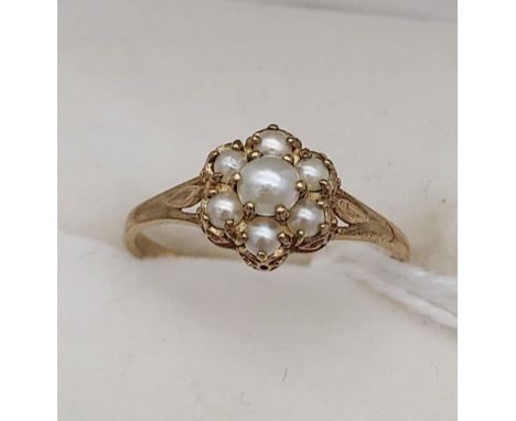 A Ladies 9ct gold and pearl set ring. Seven pearls set like a flower. [Ring size O] [1.59 Grams] 