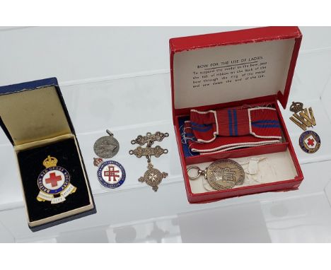 A Military 1953 Queen Elizabeth 11 Ladies Bow medal with box. Birmingham silver St Johns Ambulance service medal, British Red