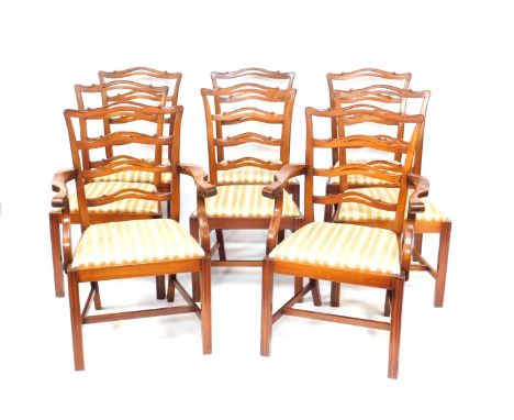A set of eight Reprodux mahogany Georgian style ladder back dining chairs, with drop in seats, raised on fluted legs, united 