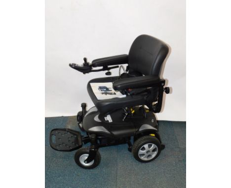 A Vietnamese made portable powerchair, with battery and user manual.