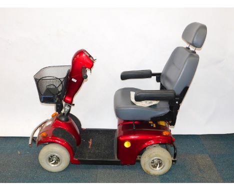 A FreeRider Mayfair red mobility scooter, model FR168-4, with battery and instructions. 