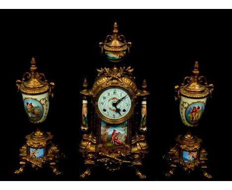 An ornate French style clock garniture set, of three pieces, comprising an 18thC style brass cased striking mantel clock, wit