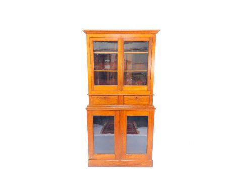 A Victorian oak bookcase, the outswept pediment above two doors, opening to reveal two shelves, above two drawers, raised ove