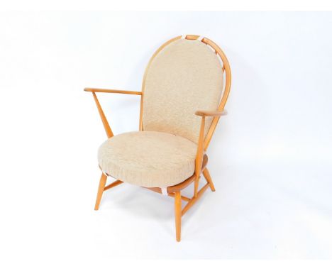 An Ercol 203 light beech and elm Windsor armchair, with loose cushion seat and back, raised on turned legs united by a H fram