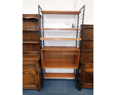 A Staples Ladderax shelving unit, with four variously sized shelves, and a two door glazed bookcase enclosing a single shelf,