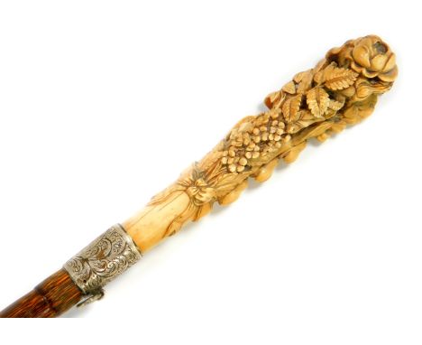 A Victorian lady's partridge wood walking cane, with an ivory handle carved with flowers and leaves, with silver ferrule, Lon