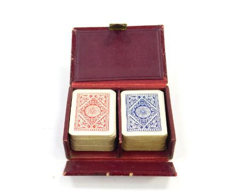 A Patience two pack playing card set, red morocco cased.