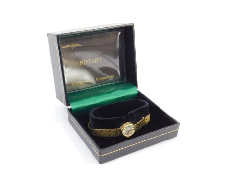 A Rotary lady's 9ct gold cased wristwatch, oval silver dial, with gilt batons, 21 jewelled movement, on a 9ct gold textured l