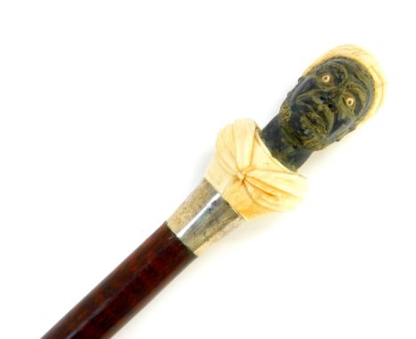 A snake wood walking stick, with an ebony and ivory carved figural handle of a Moor, white metal ferrule and ivory tip, 97.5c