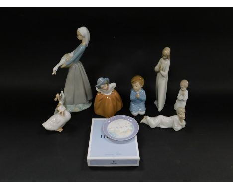 Lladro Nao porcelain figures, including a girl with a puppy and goose, No 866, boxed., kneeling children in prayer, and a Lla