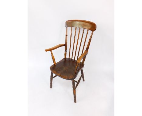 A Victorian oak and elm gentleman's stick back kitchen chair, raised on turned legs united by an H frame stretcher.