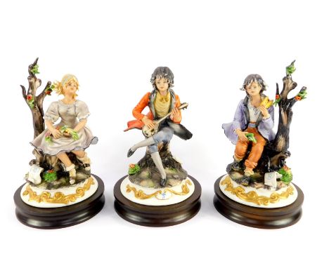 Three Capodimonte porcelain figures, modeled by Sartori, raised on wooden socle bases, comprising seated boy with a lute, sea