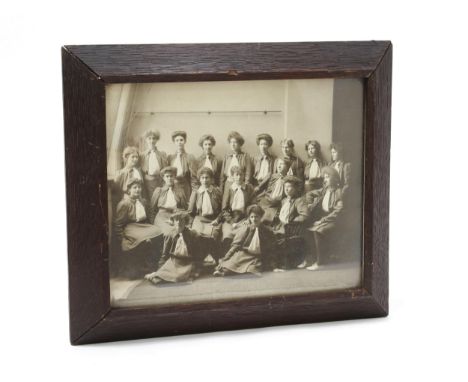 Photography - an early 20tyh century photograph, of a group of young women, in uniform, their arm patch badges with initials 