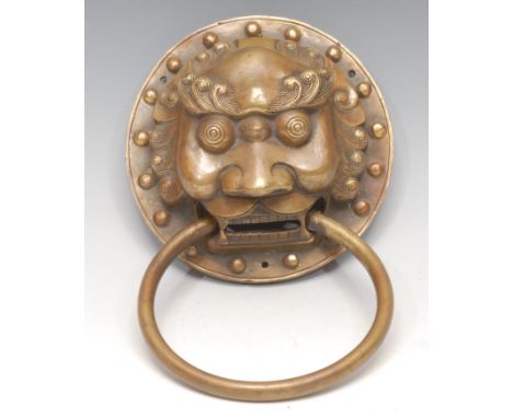 A substantial Chinese brass door knocker, cast as the head of a temple lion, 15cm diam 