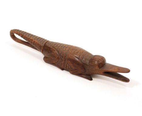 Nutcrackers - a 19th century treen novelty screw-action nut cracker, carved as a crocodile, 22cm long, c.1870 