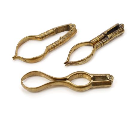 Nutcrackers - an early 18th century brass lever-action nut cracker, decorated with punched flowerheads, 10cm long, c.1720; ot