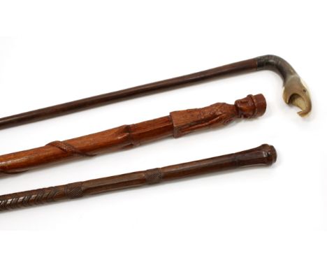 A Colonial novelty walking stick, the horn handle carved as the head of a bird, 93cm long; an African walking stick, the pomm