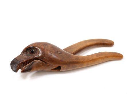 Nutcrackers - a Black Forest lever-action novelty nut cracker, carved and painted as the head of an eagle, glass eyes, 21.5cm