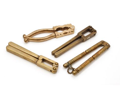 Nutcrackers - a 19th century brass lever-action nut cracker, ring-turned, sprung mechanism, 12cm long; others (4) 