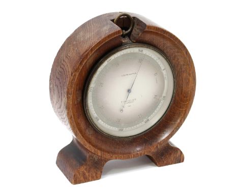 An early 20th century lacquered brass aneroid barometer, 11cm silvered register inscribed T Wheeler, London 338, oak desk top