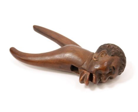 Nutcrackers - a Black Forest lever-action novelty nut cracker, carved as the head of a gentleman of African descent, 21.5cm l