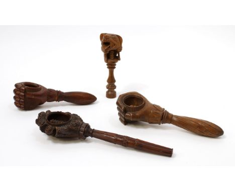 Nutcrackers - a Black Forest novelty screw-action nut cracker, carved as a fist grasping a walnut, lotus haft, 20.5cm long, c